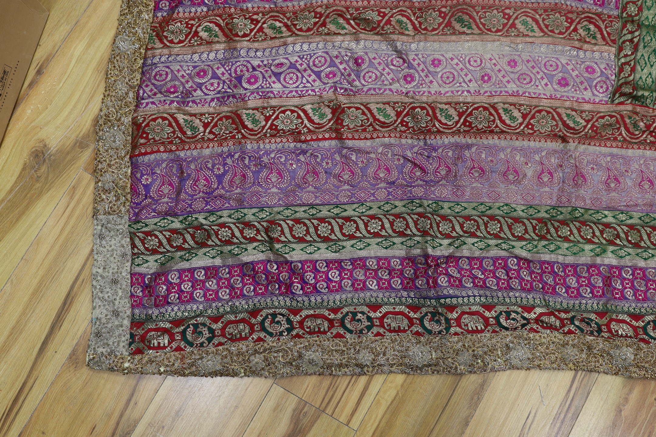 A French 18th century woolwork cushion, 2 chair covers, another panel, a tasselled brocade cushion and an Indian metallic brocaded patchworked cover